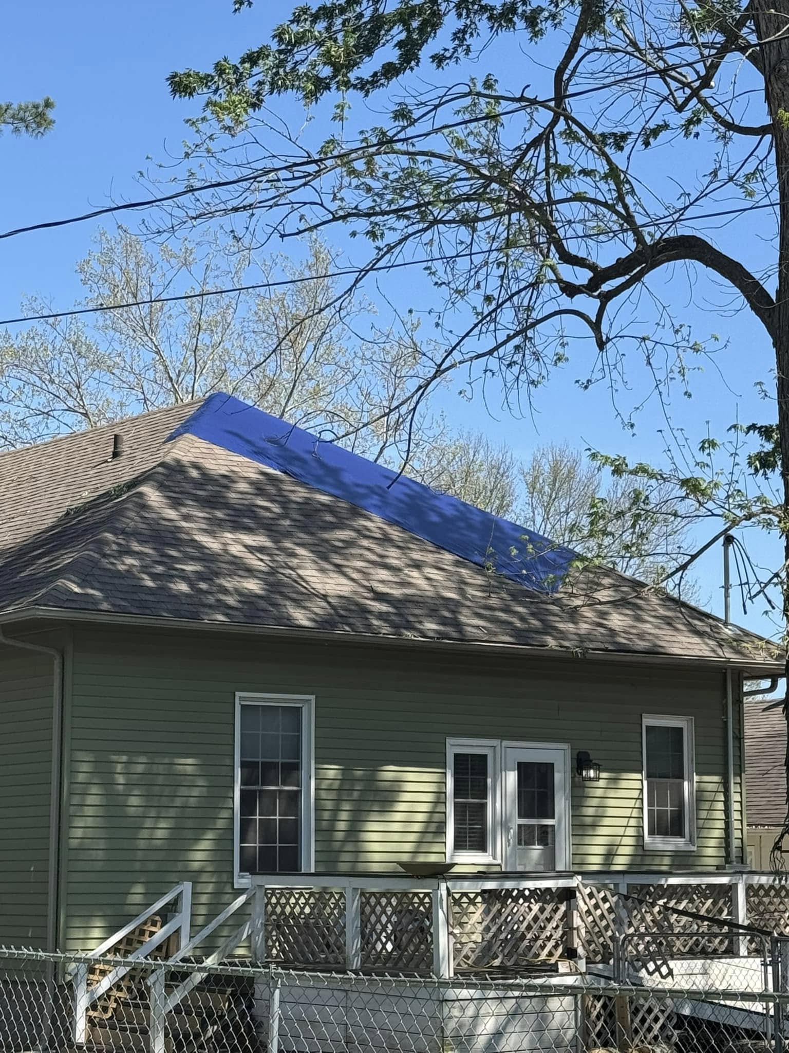 After emergency tree removal: home cleared of fallen tree with debris hauled off in Monett, MO